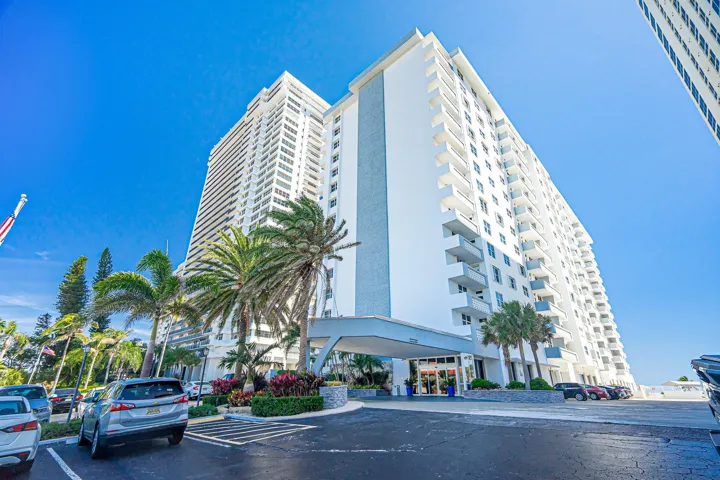 Modern high-rise exterior with multiple balconies and a covered entrance