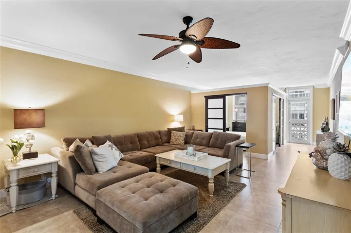 Expansive living space featuring crown molding, recessed lighting, and tile flooring