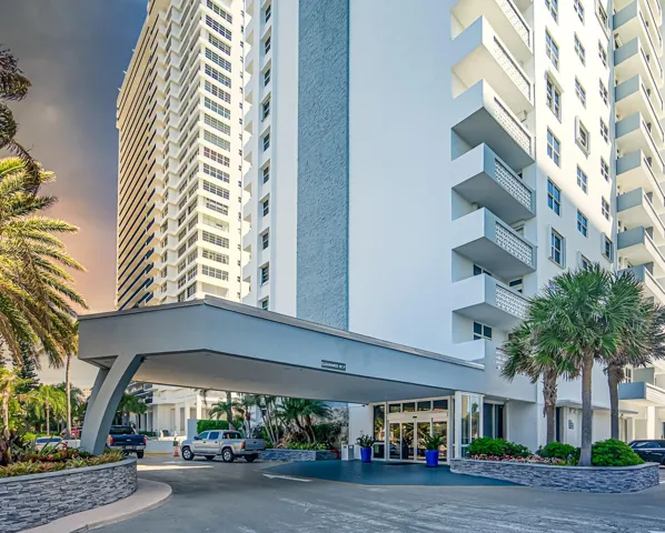 Building exterior with a portico entry, a multi-story facade, and visible balconies