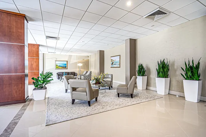 Wood-paneled elevator, tiled flooring, textured wall finishes, recessed lighting, and a drop ceiling