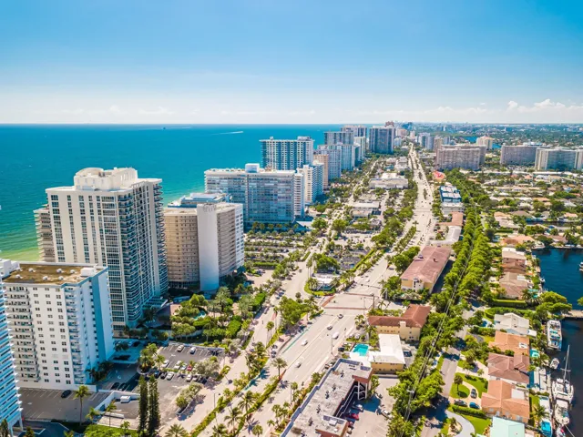 Coastal city setting with high-rise buildings, extensive waterway, and lush landscaping