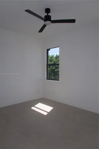Bedroom 3, Matte black three-blade ceiling fan, single-hung window with dark frame, and large-format tile flooring