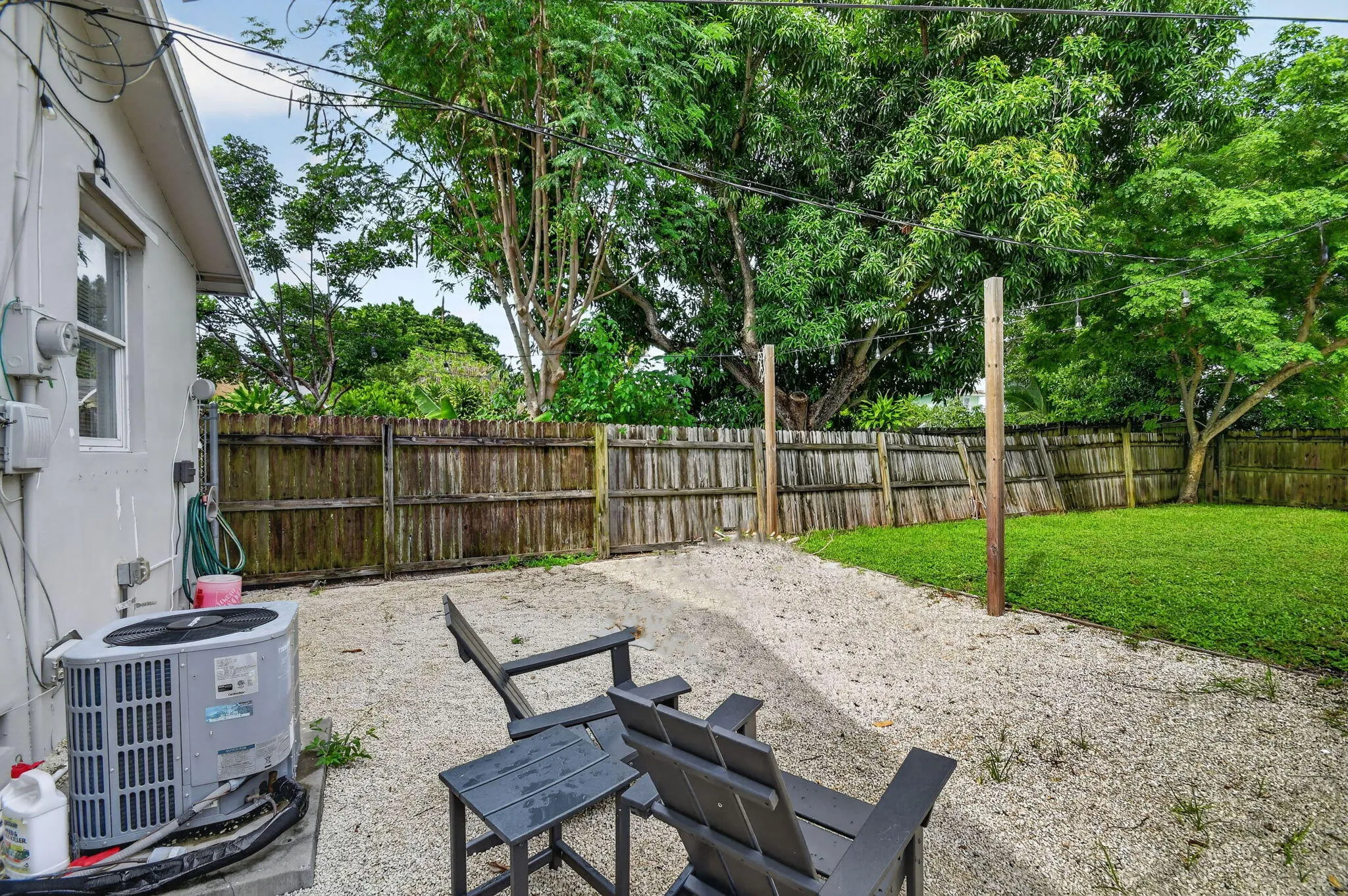 Fenced in, sitting area with gravel