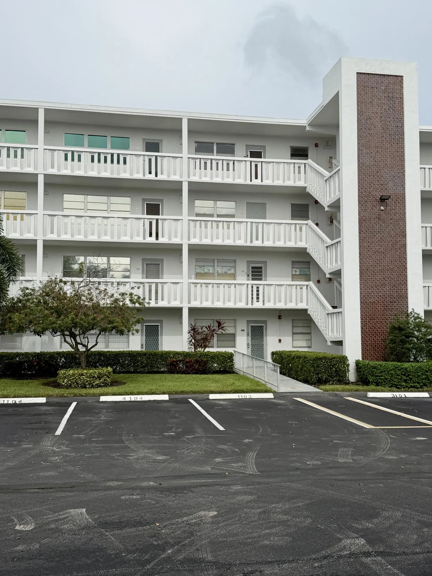 View of Condo from Parking, 4th Floor (Hurricane Windows and Door with Blueish Tint)