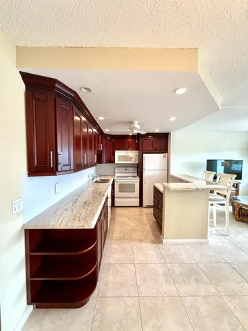Open Kitchen with Cherrywood Cabinets and Granite