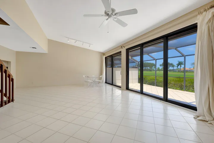 Tall impact sliding glass doors showcase magnificent panoramic views of the Champion Golf Course.