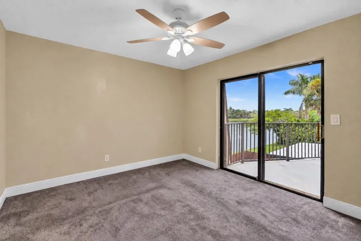 SECOND BEDROOM ALSO WITH SLIDING DOORS TO BALCONY OVERLOOKING BEAUTIFUL LAKE