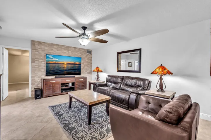 LIVING ROOM WITH CUSTOM STONE WALL