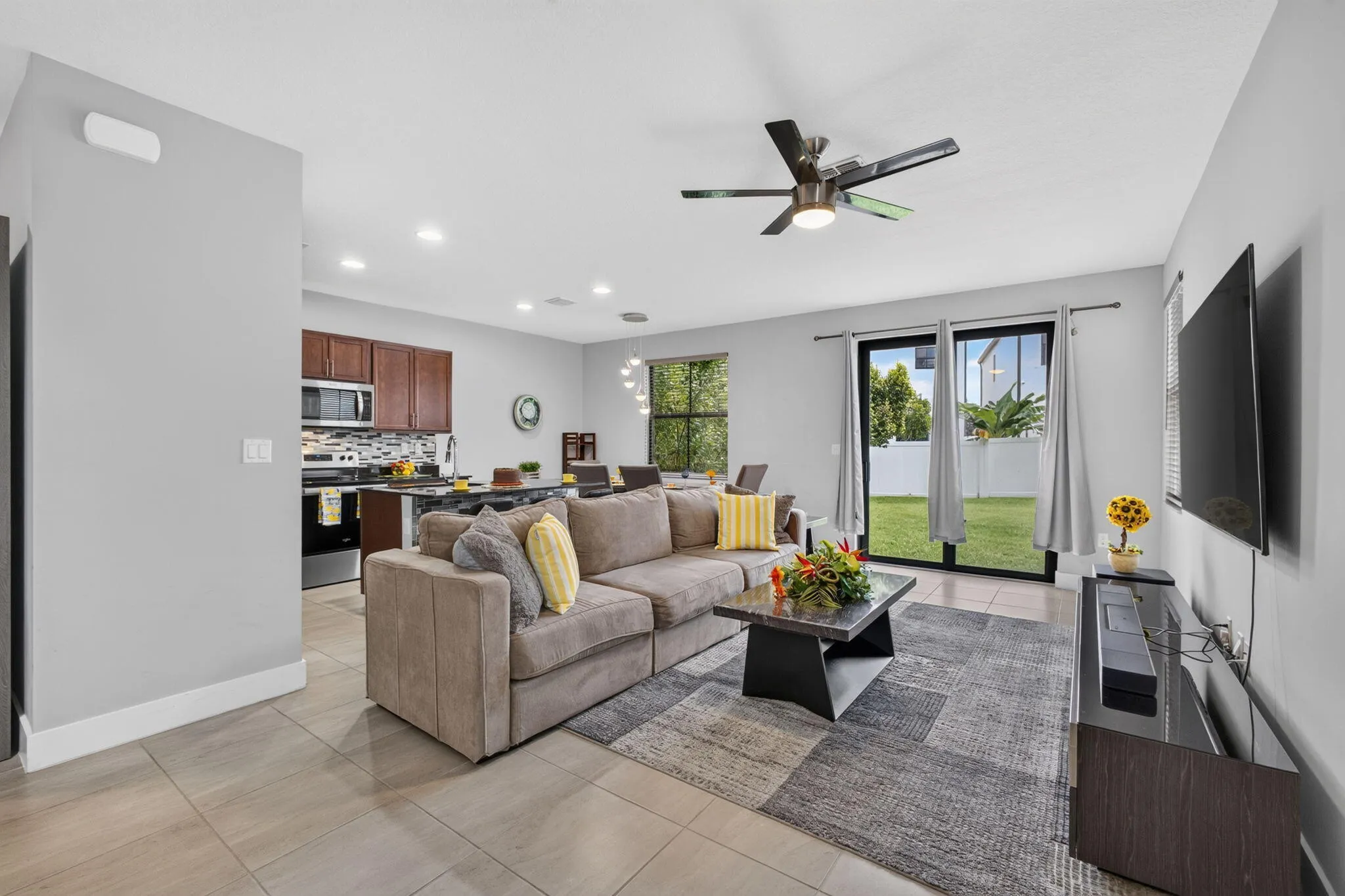 Living areas with 18"x18" neutral tile flooring and 6" baseboards.
