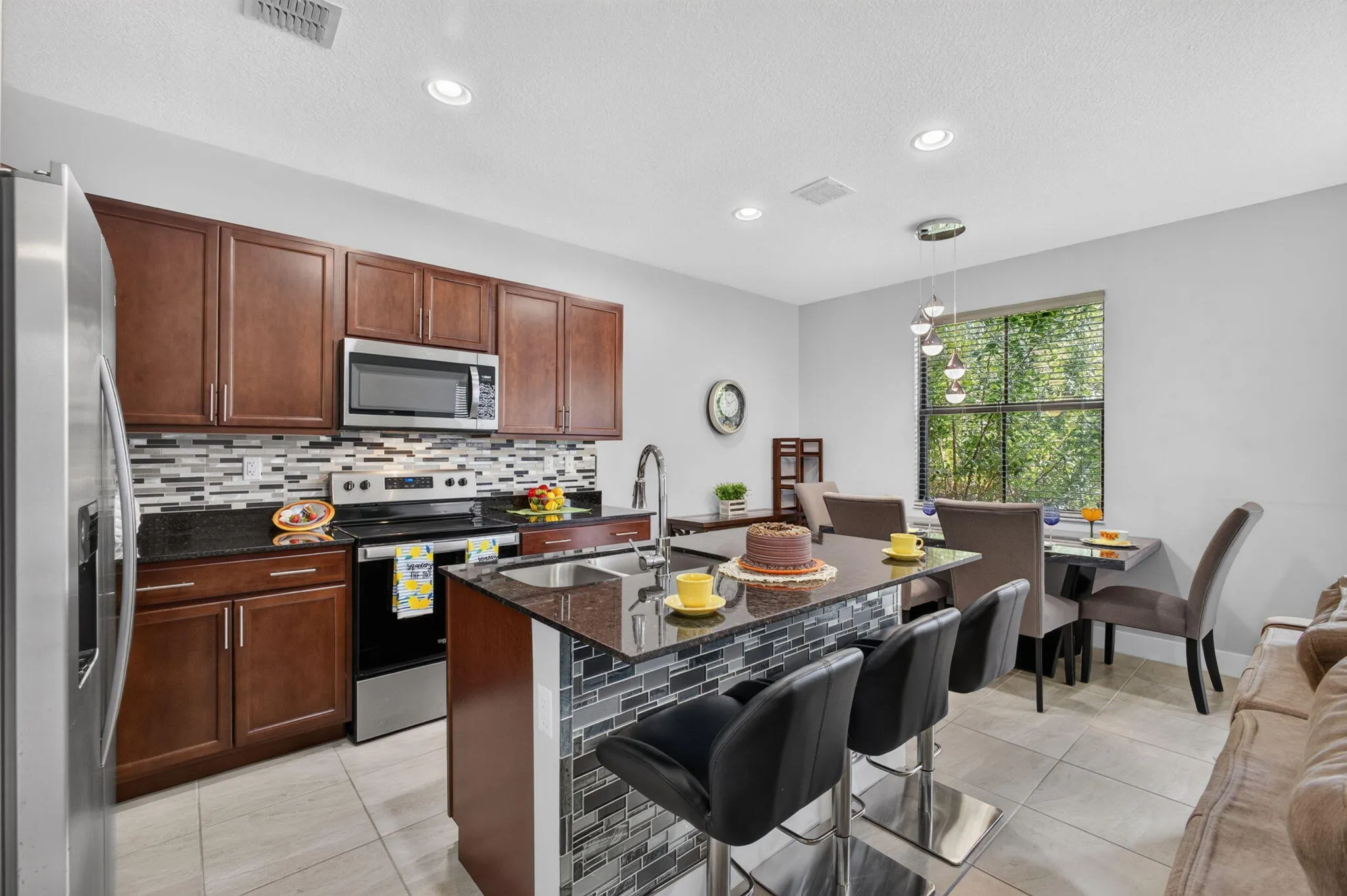 Savor morning coffee at the island with glass kick plate.