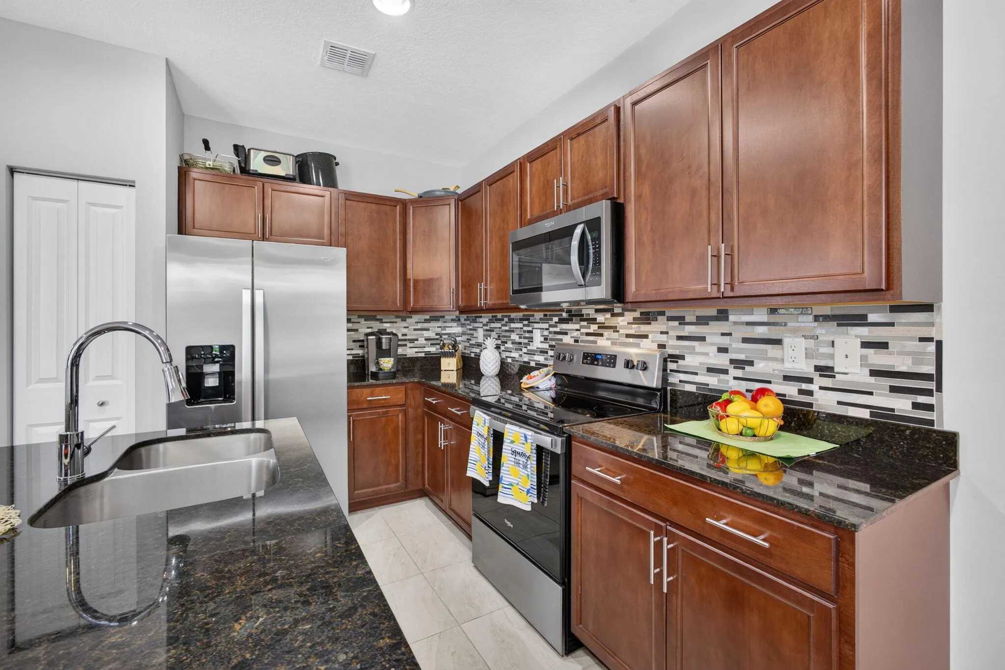 Gorgeous mahogany cabinets, full glass backsplash and granite counters.