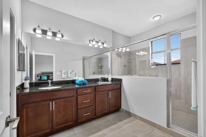 Primary bath features double basin vanity with undermount sinks.