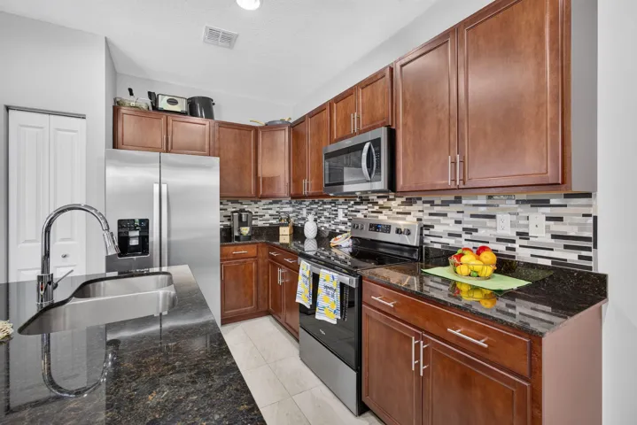 Gorgeous mahogany cabinets, full glass backsplash and granite counters.