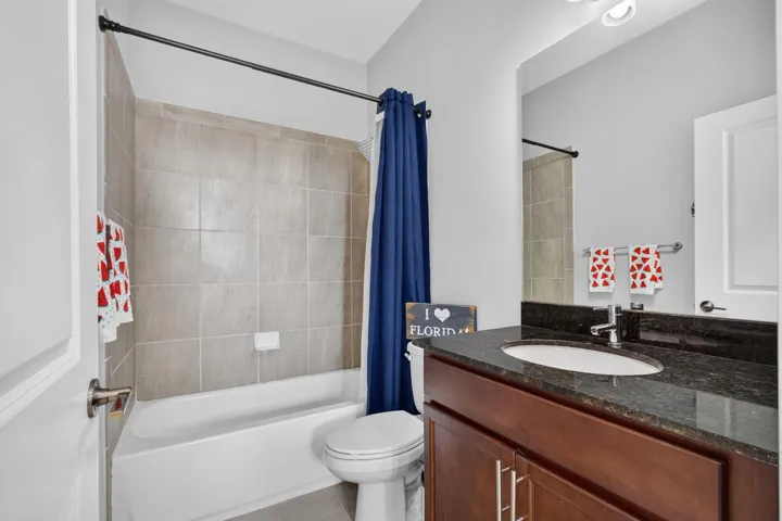 Guest bath features combination tub/shower and counter height vanity.