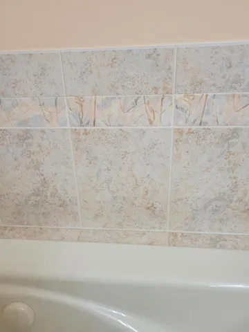 a close up view of the tile that graces the sides of the jetted spa tub.
