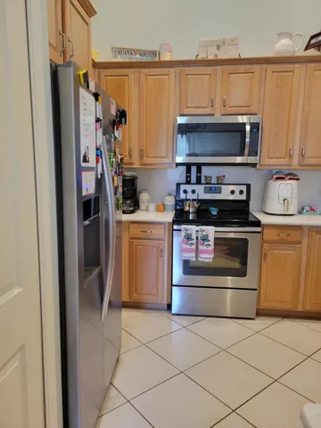 All Whirlpool brand appliances stay with the home. Micro, Refrig, Dishwasher, Range and Disposal too. Note the larger cabinets as well as the uplighting which serves as a night light during the evening. Tile cut on a diagonal.