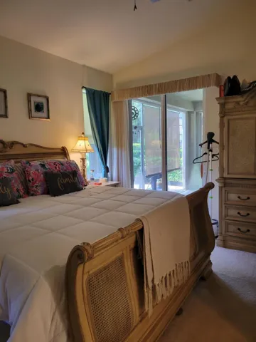 Natural light bathes the master bedroom with privacy sheers that allow access to the screened porch once your guests or children have gone to bed.