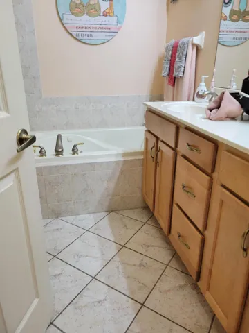 Diagonal tile graces the master bath floor