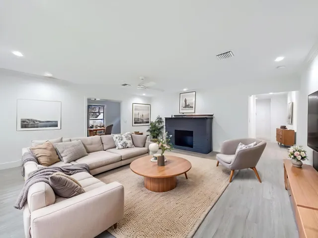 Recessed lighting, wood-finish flooring, a ceiling fan, and a built-in fireplace