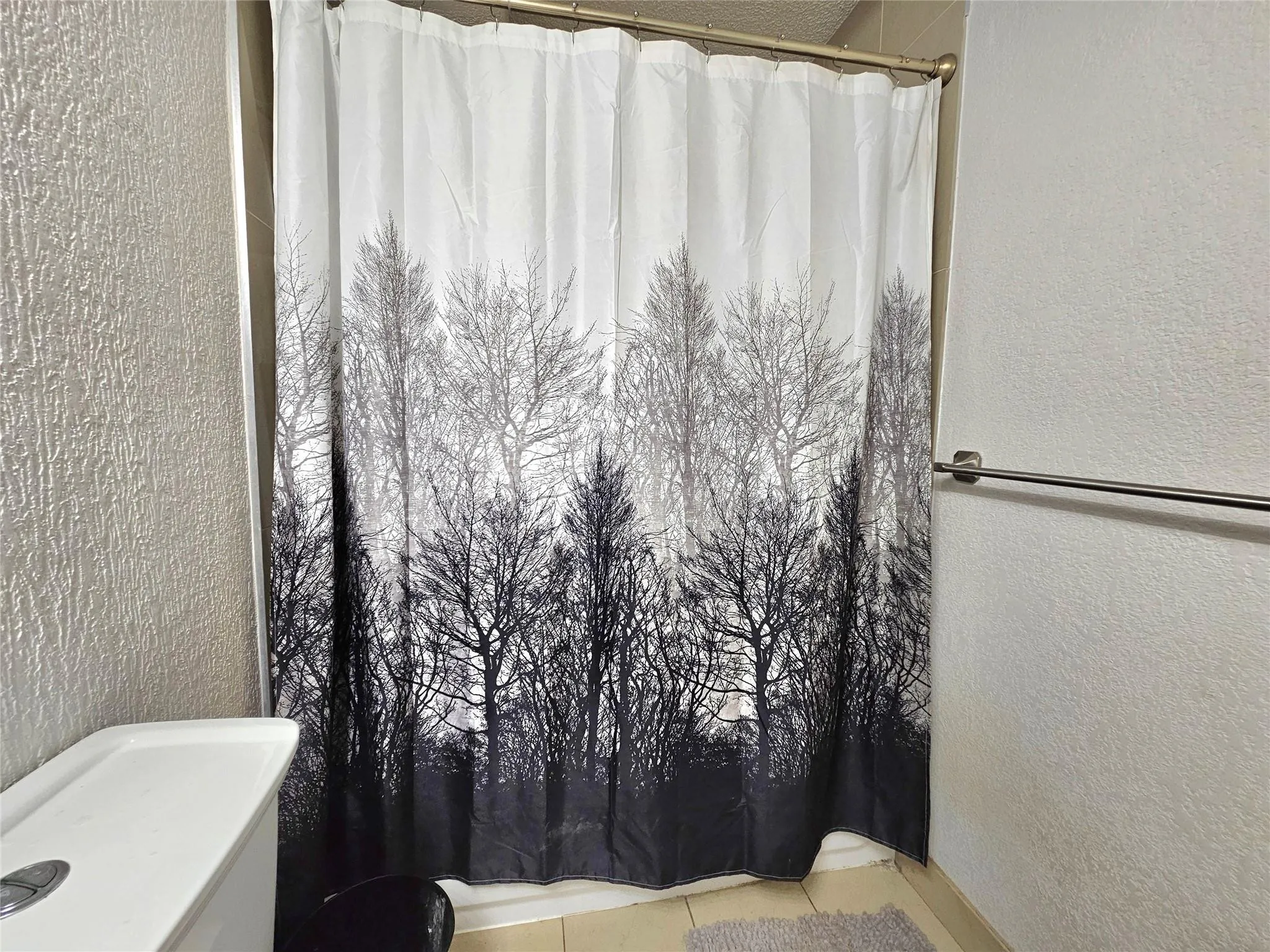 SHOWER IS TILED UP TO THE CEILING