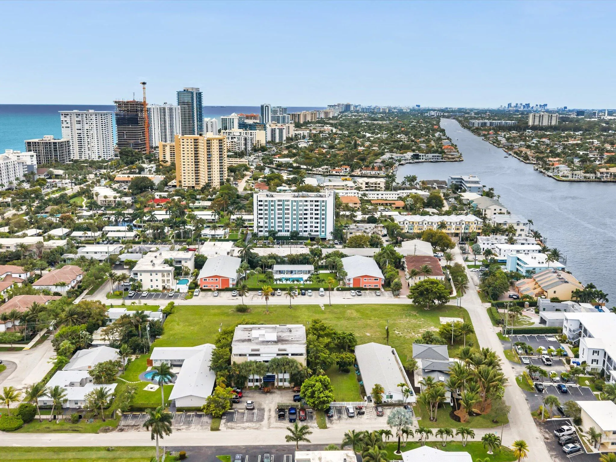Aerial perspective showcasing coastal proximity, urban development, extensive waterway, and varied architectural styles