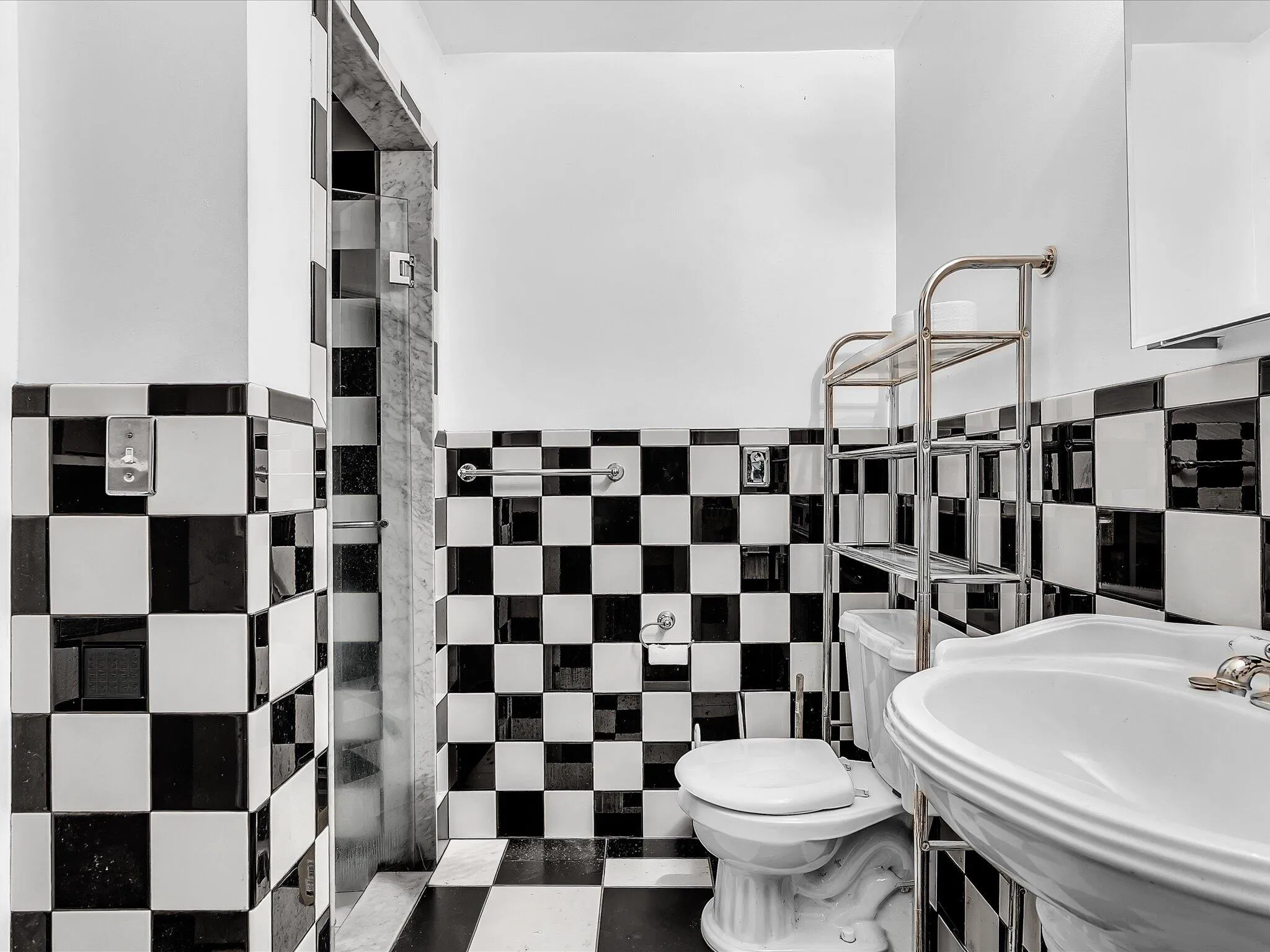 Black and white checkerboard tile flooring and wainscoting