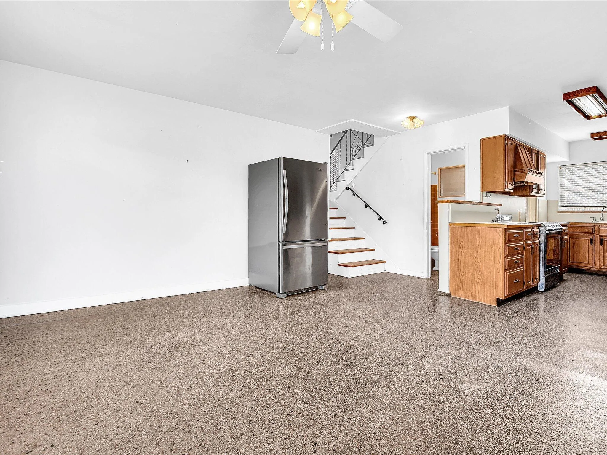 Terrazzo-style flooring extends through the open concept space
