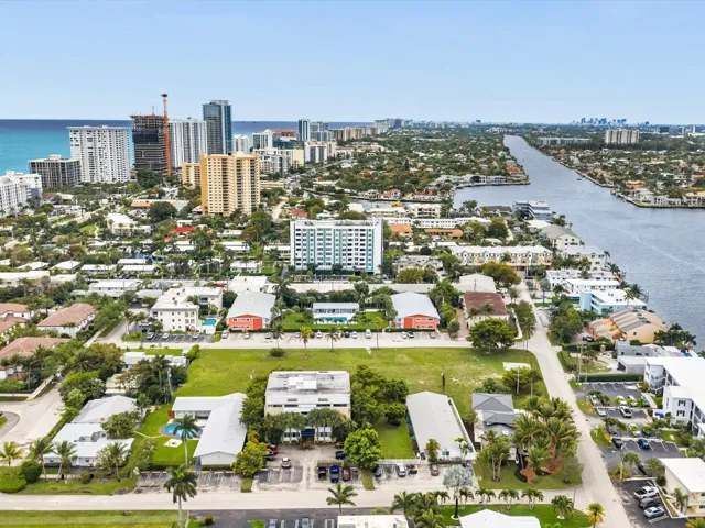 Aerial perspective showcasing coastal proximity, urban development, extensive waterway, and varied architectural styles