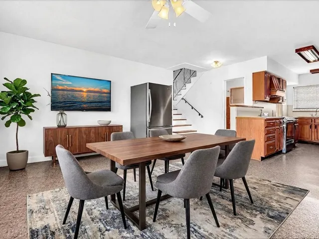 Open-concept living space with hard-surface flooring and a ceiling fan