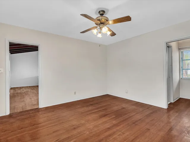 Wood-finish flooring with a ceiling fan light fixture