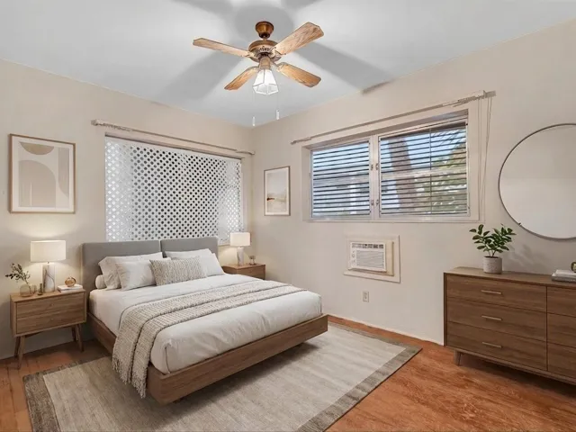 Wood-finish flooring with a ceiling fan light fixture