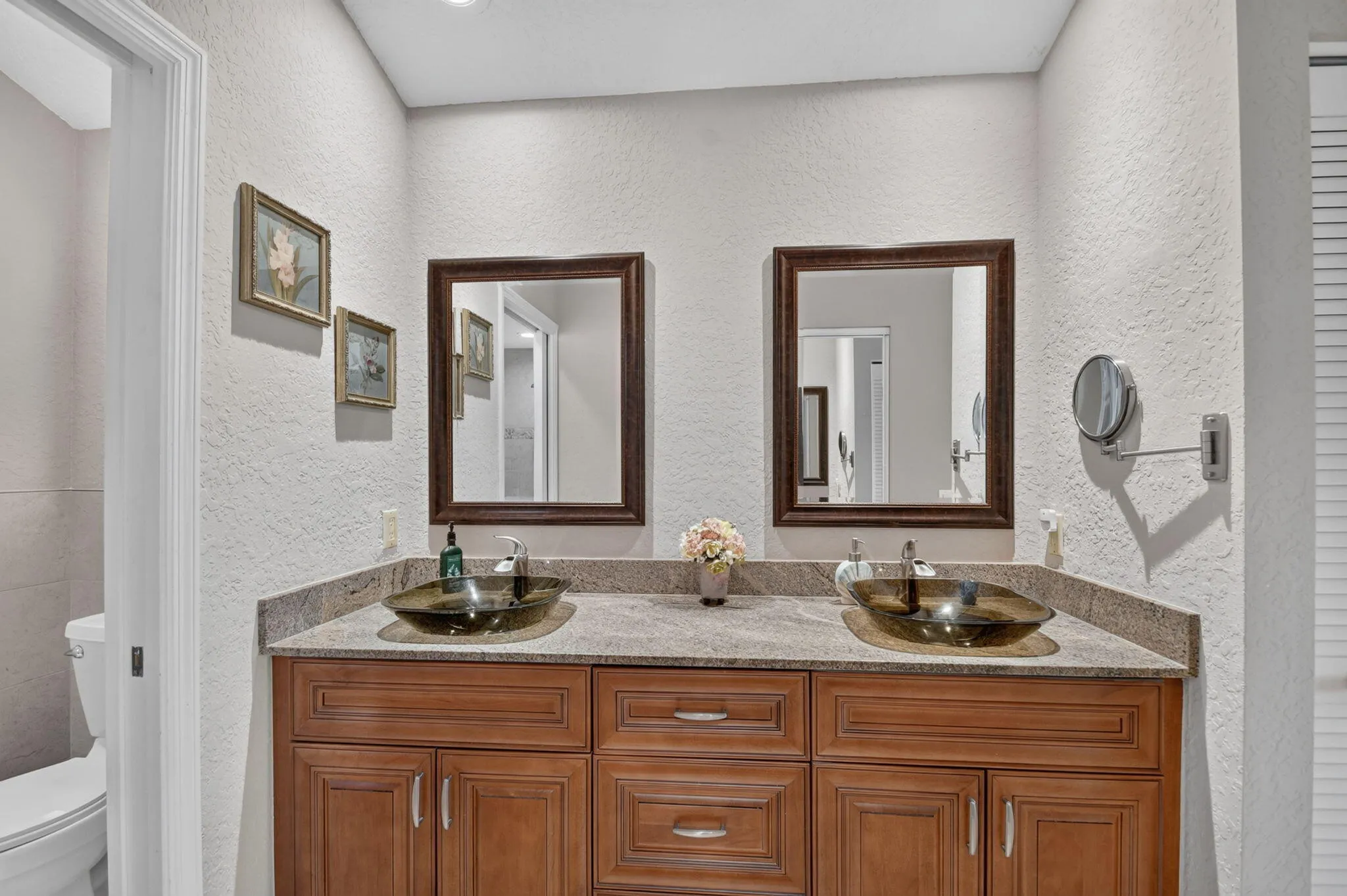 Beautiful wood panel cabinetry-granite countertops-gorgeous glass bowl sinks.