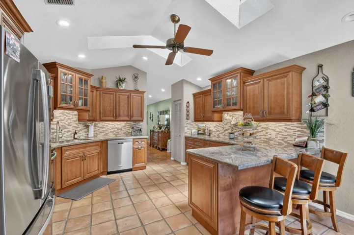 Beautiful wood panel cabinetry- granite countertops-tile backsplash-stainless appliances.