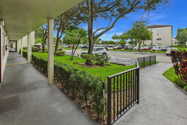 Handicap accessible ramp right to the covered walkway with an open-air corridor.