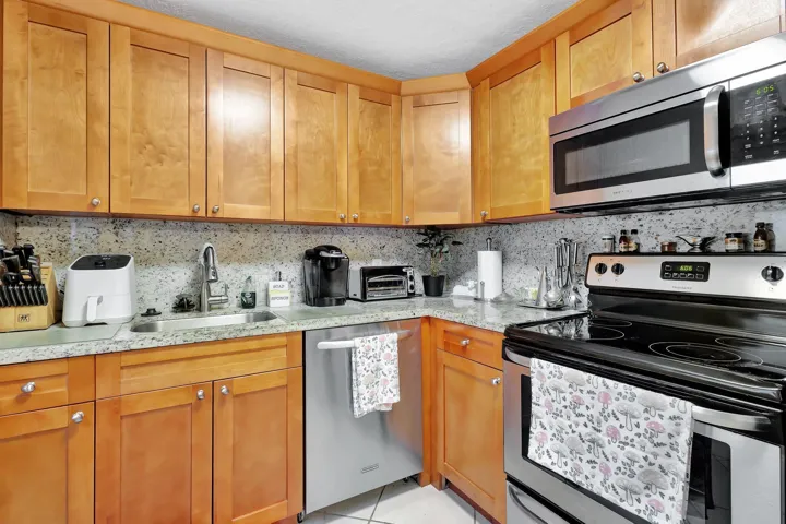 Beautiful wood cabinetry-granite countertops and full backsplash-stainless appliances.
