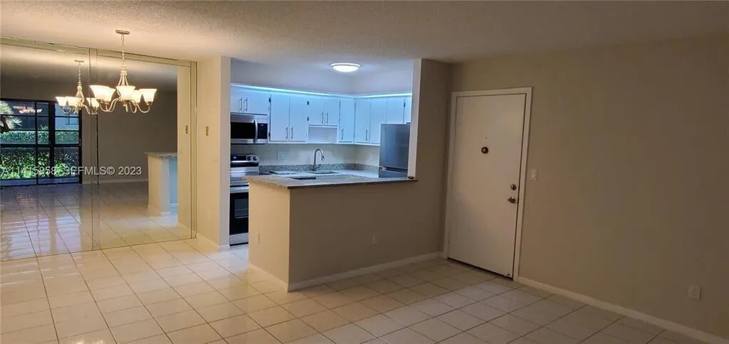 View of Renovated Kitchen and Dining Area, Plus Front Entrance to Unit