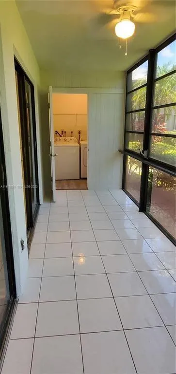 View of Glass Enclosed Sun Room with view to Laundry Room