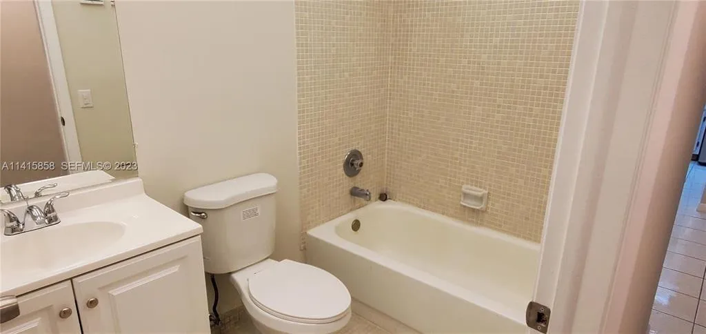 Hallway Bathroom with Newer Toilet and Vanity