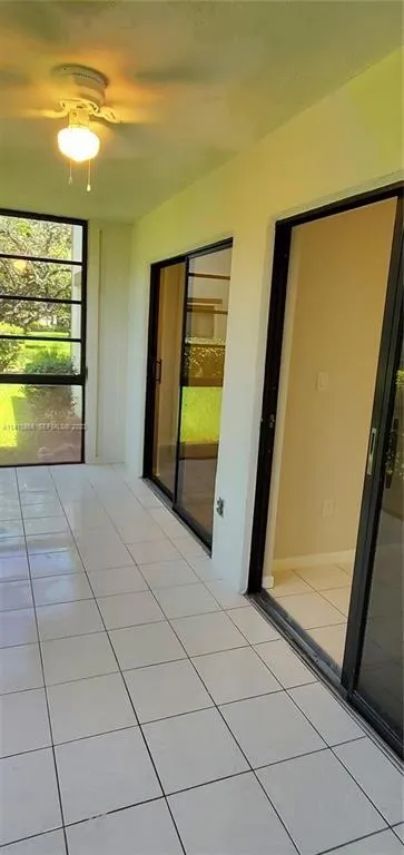 Another View of Sun Room showing 2 Sliding Glass Doors, 1 set to Living Room, 1 Set to 2nd Bedroom