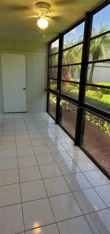 View of Glass Enclosed Sun Room with view to Laundry Room