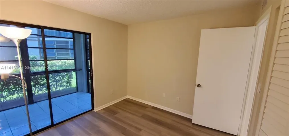Partial View of 2nd Bedroom with Sliding Glass Doors to Sunroom