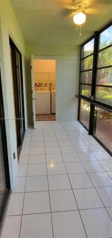 View of Glass Enclosed Sun Room with view to Laundry Room