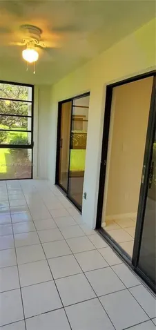Another View of Sun Room showing 2 Sliding Glass Doors, 1 set to Living Room, 1 Set to 2nd Bedroom