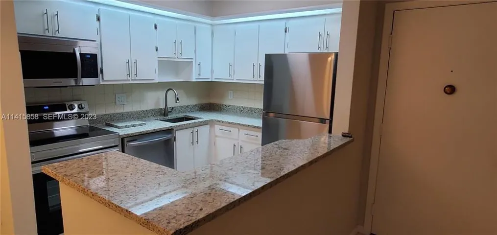Another view of Renovated Kitchen with Granite Counters and all Stainless Steel Appliances