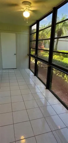 View of Glass Enclosed Sun Room with view to Laundry Room