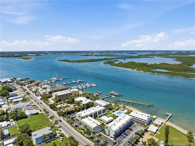 Expansive aerial view highlighting the community’s location along the water with nearby marinas, mangrove islands, and navigable waterways.