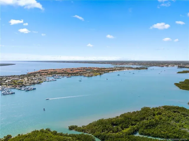 Aerial view highlights the surrounding waterways, marinas, and boating access that define this coastal location.
