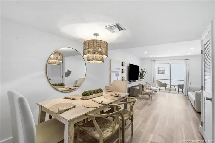 Open dining and living spaces create an easy flow for everyday living and entertaining, with sliding glass doors extending the space outdoors.