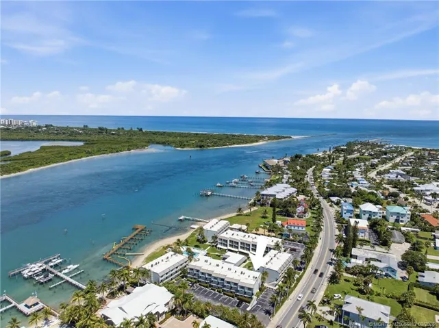 Wide aerial view with arrow identifying the building and showcasing the community’s exceptional proximity to the Fort Pierce Inlet and Atlantic Ocean.