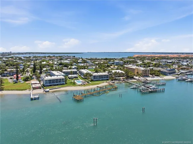 Wide aerial view captures the community along the water with docks, marinas, and the Intracoastal beyond.